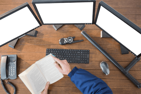 security officer reading book with multiple transparent monitors - Download Free Stock Videos Pikwizard.com
