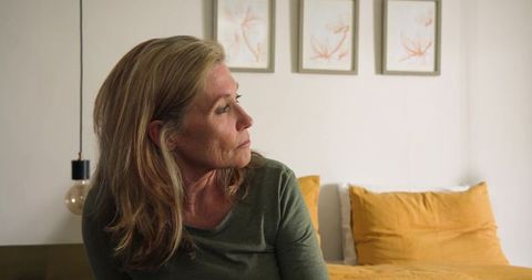 Senior woman at home relaxing in contemporary cozy bedroom