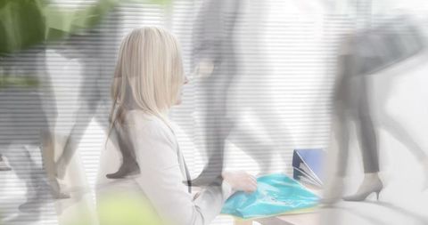 Caucasian Businesswoman Analyzing Documents in Dynamic Environment