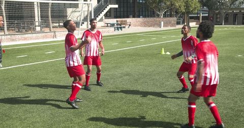 Teen Soccer Players Skillfully Practicing Ball Control on Field