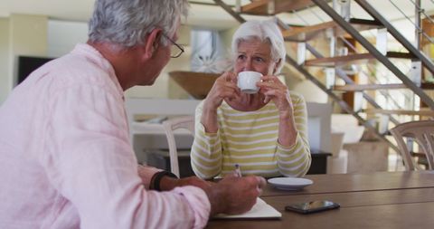 Senior Couple Discussing Finances at Home Over Coffee - Download Free Stock Images Pikwizard.com