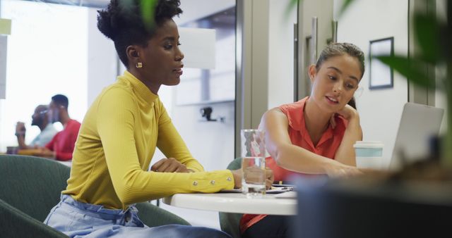 Multiracial women collaborating in modern office setting - Download Free Stock Images Pikwizard.com