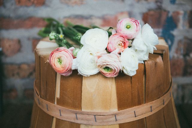 Rustic Bouquet on Wooden Basket Against Brick Wall - Download Free Stock Photos Pikwizard.com