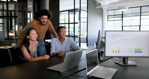 Smiling colleagues engaging in productive office discussion