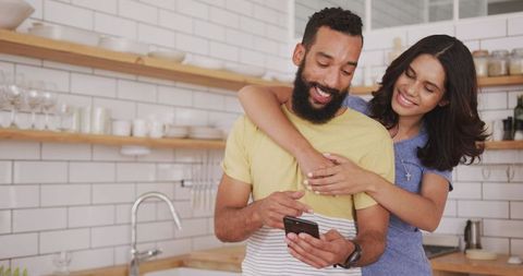 Couple enjoying weekend relaxing in home kitchen