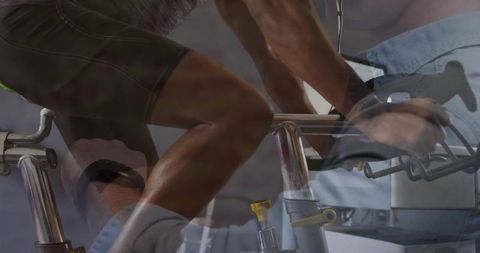 Trainer Adjusting Bike Resistance for Athletic Workout