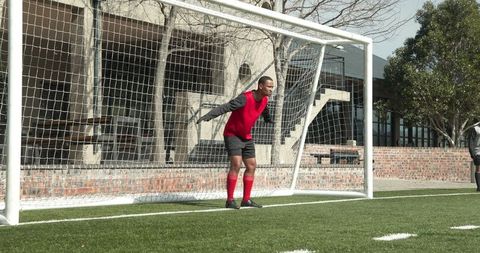 Young Goalkeeper Preparing to Save on Urban Field