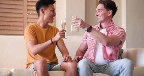 Diverse Male Couple Toasting at Home Celebrating Togetherness