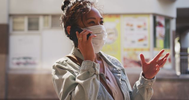 Woman Wearing Face Mask Talking on Phone on Urban Street - Download Free Stock Images Pikwizard.com