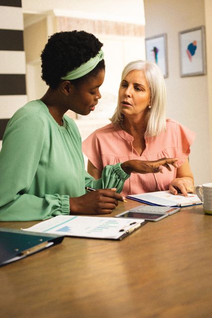 Senior caucasian woman talking with african american woman about work - Download Free Stock Photos Pikwizard.com