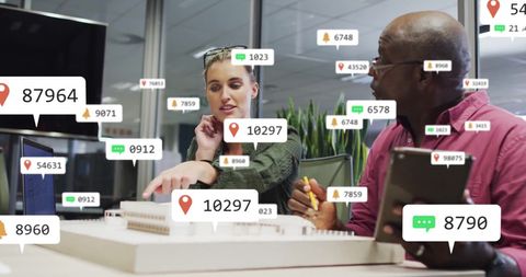 Architects evaluating building model with data notifications overlay