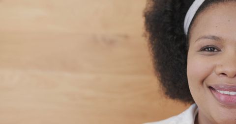 Smiling Plus Size Biracial Woman Relaxing Indoors