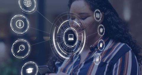 Mid-adult woman holding smartphone and viewing augmented reality HUD in coworking space