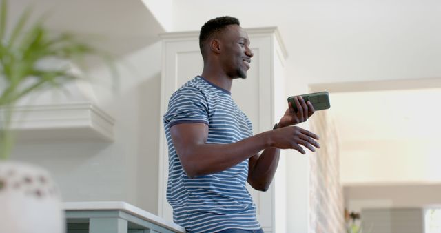 Smiling Man Talking on Smartphone in Modern Home - Download Free Stock Images Pikwizard.com