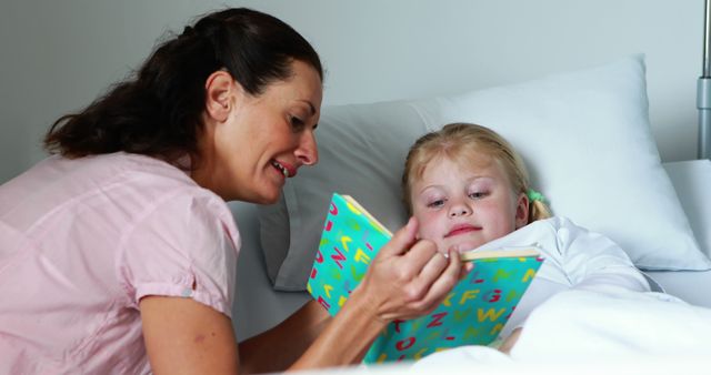 Mother Reading Bedtime Story to Daughter in Hospital Bed - Download Free Stock Images Pikwizard.com