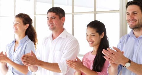 Diverse Team Applauding in Modern Office Environment