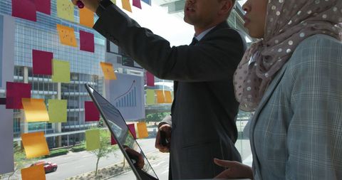 Business Team Brainstorming with Sticky Notes in Modern Office