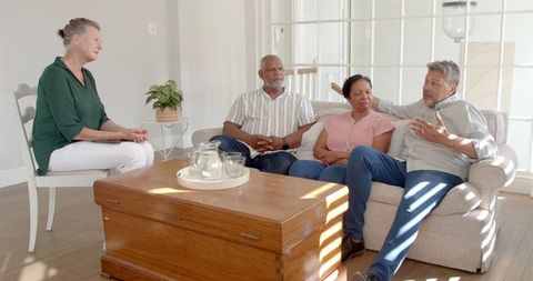 Senior Friends Enjoying Relaxation in Bright Living Space