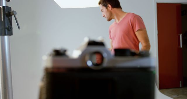 Photographer Setting Up Camera in Studio With Blurred Background - Download Free Stock Images Pikwizard.com