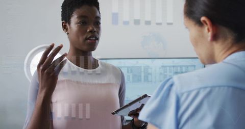 Colleagues discussing financial data with digital interface overlays