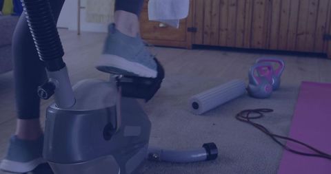 Focused Home Workout Scene Featuring Stationary Bike and Equipment