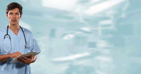 Confident caucasian male surgeon writing on clipboard