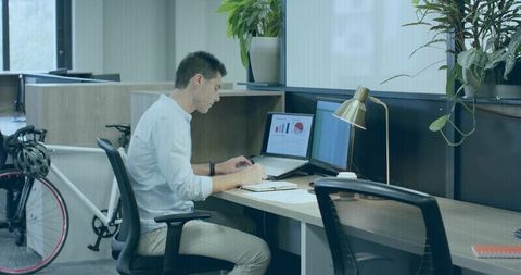 Focused Professional Working at Modern Open Office Desk