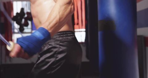 Athletic Boxer Jumping Rope in Gym with Hand Wraps