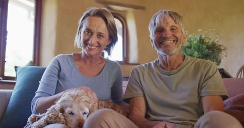 Senior Couple Enjoying Video Call with Pet Dog Relaxed at Home