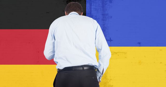 Rear view of caucasian businessman against germany and ukraine flag design background. ukraine crisis, invasion and international relations concept