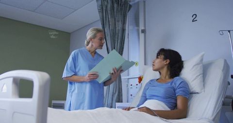 Nurse Explaining Treatment Plan to Relaxed Patient in Hospital Room