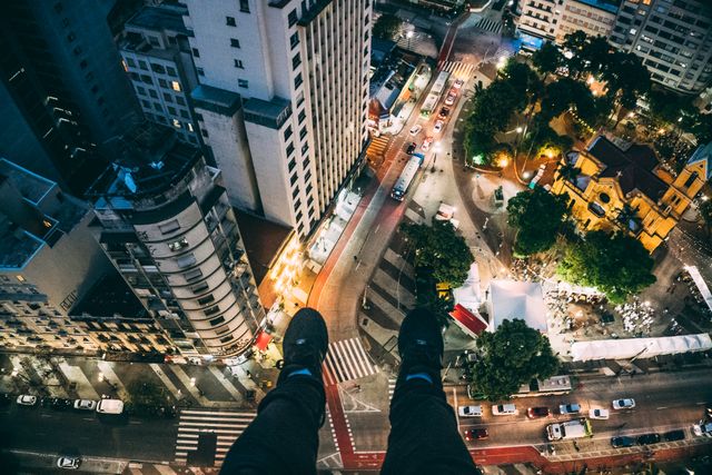 Feet Dangling Over Busy City Streets at Night - Download Free Stock Images Pikwizard.com