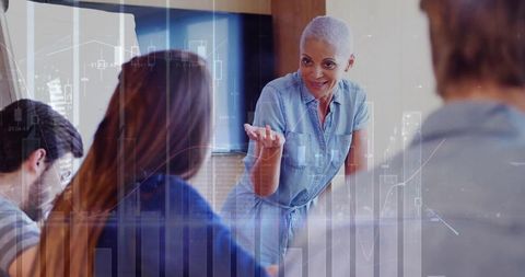 Confident mature businesswoman leading financial team discussion