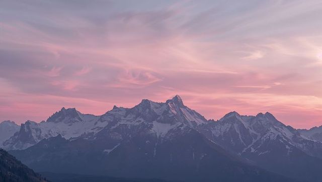 Alpine Mountain Peaks Under Pastel Pink Sky at Dusk