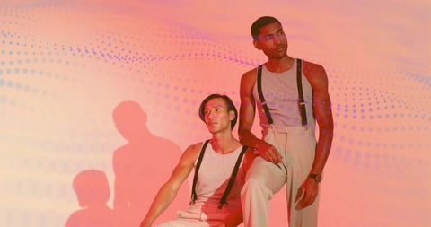 Contemporary fashion models in tank tops and suspenders with modern gradient background