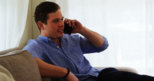 Man Relaxing on Couch While Talking on Phone - Download Free Stock Images Pikwizard.com