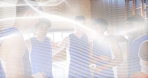 Basketball Team Huddling Showing Unity in Gymnasium