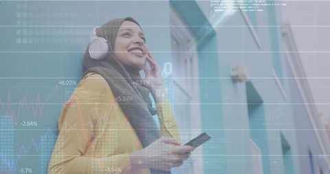 Smiling Woman Engaging with Technology Amid Financial Data Visualization