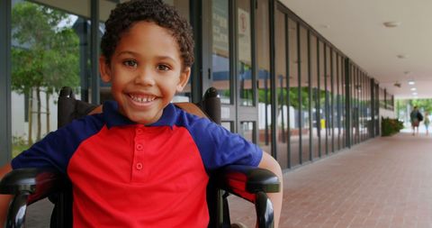 Smiling Schoolboy in Wheelchair in Bright Corridor - Download Free Stock Images Pikwizard.com