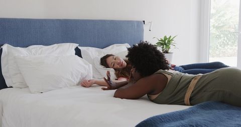 Relaxed Friends Enjoy Vacation in Hotel Room