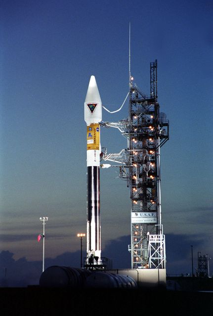 After tower rollback just before dawn on Launch Pad 36A, Cape Canaveral Air Force Station, NASA’s Tracking and Data Relay Satellite (TDRS-H) sits bathed in spotlights before liftoff atop an Atlas IIA/Centaur rocket. One of three satellites (labeled H, I and J) being built by the Hughes Space and Communications Company, the latest TDRS uses an innovative springback antenna design. A pair of 15-foot-diameter, flexible mesh antenna reflectors fold up for launch, then spring back into their original cupped circular shape on orbit. The new satellites will augment the TDRS system’s existing Sand Ku-band frequencies by adding Ka-band capability. TDRS will serve as the sole means of continuous, high-data-rate communication with the Space Shuttle, with the International Space Station upon its completion, and with dozens of unmanned scientific satellites in low earth orbit