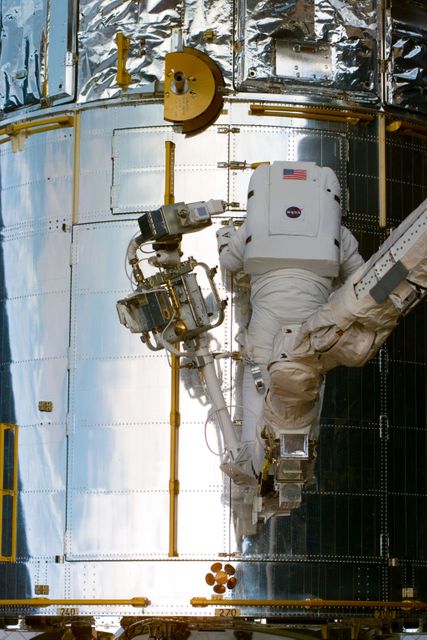 S82-E-5242 (14 Feb. 1997) --- Astronaut Steven L. Smith, STS-82 mission specialist, prepares to open aft shroud of Hubble Space Telescope (HST) for repair. This view was taken with an Electronic Still Camera (ESC).