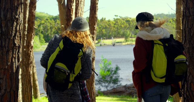 Two Friends Enjoying Hiking Adventure Near Lake During Daytime - Download Free Stock Images Pikwizard.com