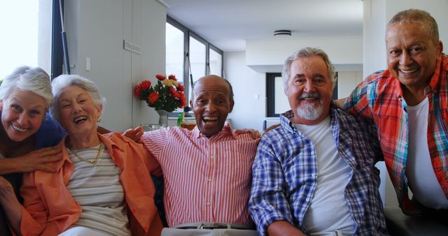 Diverse group of senior friends smiling together indoors - Download Free Stock Images Pikwizard.com