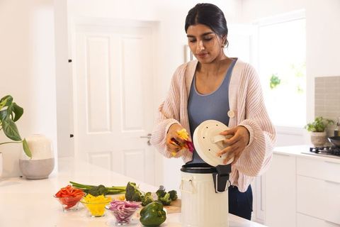 Asian Woman Preparing Meal with Slow Cooker in Modern Kitchen