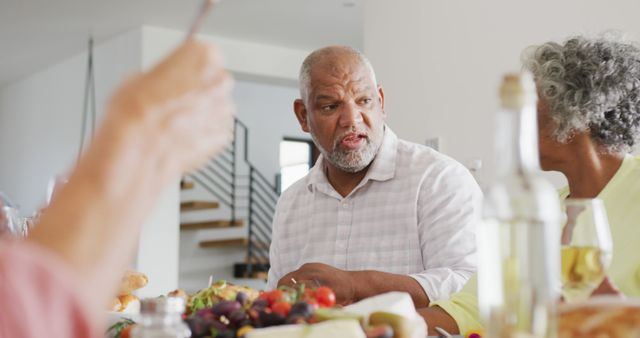 Senior Adults Enjoying Conversation Over a Meal at Home - Download Free Stock Images Pikwizard.com