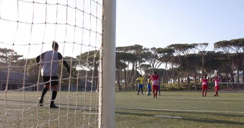 Youth Soccer Players Practicing Teamwork on Sunny Day