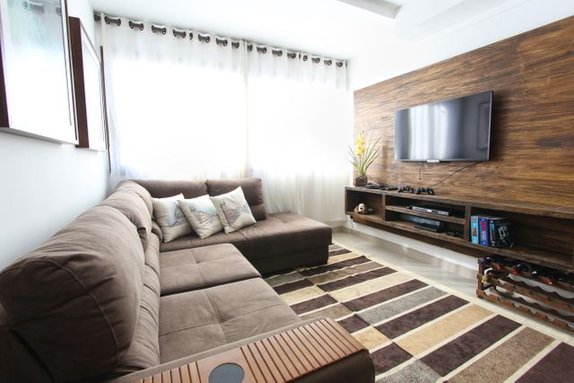Modern Living Room with Brown Sofa and Wooden Accents - Download Free Stock Photos Pikwizard.com