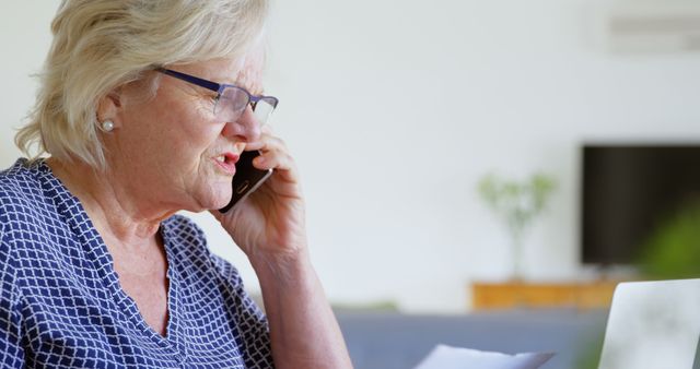 Senior Woman on Phone Handling Home Finances in Living Room - Download Free Stock Images Pikwizard.com