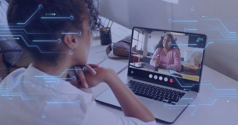 Woman attending remote video call on laptop for teamwork and virtual collaboration in modern office